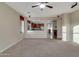 Open-concept living room featuring plush carpeting and easy access to the kitchen through a large opening at 15635 W Montecito Ave, Goodyear, AZ 85395