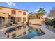 Beautiful backyard swimming pool reflecting home, palm trees, and blue sky at 15635 W Montecito Ave, Goodyear, AZ 85395