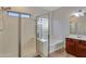 Shower featuring glass doors, and tile, and a window letting in natural light at 15635 W Montecito Ave, Goodyear, AZ 85395