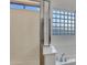 A sleek shower with modern fixtures is next to a tub and a glass block window at 15635 W Montecito Ave, Goodyear, AZ 85395