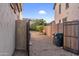 View of the side yard with gravel, brick wall and view of the neighbor's landscaping and clear sky at 15635 W Montecito Ave, Goodyear, AZ 85395