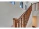 Carpeted staircase with wood banister and natural light at 15635 W Montecito Ave, Goodyear, AZ 85395