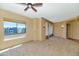 Bright bedroom with neutral walls, a ceiling fan, a large window and decorative curtains for added comfort at 15802 N 71St St # 604, Scottsdale, AZ 85254