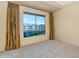 Bedroom with tan walls, carpeted floors, floor-to-ceiling window, and full-length drapes at 15802 N 71St St # 604, Scottsdale, AZ 85254