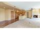 Open-concept living area with a fireplace and an adjacent kitchen featuring wood cabinetry and granite countertops at 15802 N 71St St # 604, Scottsdale, AZ 85254