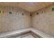 The steam room has tile floors, tile walls, and a built-in bench at 15802 N 71St St # 604, Scottsdale, AZ 85254