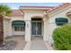 The front entrance features security screen doors, xeriscaping, and awnings at 16004 W Falcon Ridge Dr, Sun City West, AZ 85375