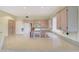 Kitchen featuring light cabinets, white appliances, and light countertops at 16004 W Falcon Ridge Dr, Sun City West, AZ 85375