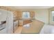 Kitchen featuring light cabinets, white appliances, and light countertops at 16004 W Falcon Ridge Dr, Sun City West, AZ 85375