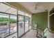 Enclosed patio with tile flooring, glass windows, a ceiling fan, and outdoor seating at 16004 W Falcon Ridge Dr, Sun City West, AZ 85375