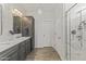 Luxurious bathroom featuring marble countertops, double sinks, wood cabinets and spacious glass-enclosed shower at 175 E Santa Lucia Ln, Queen Creek, AZ 85140