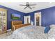 Bedroom showcasing beautiful blue accent wall, wooden furniture, ceiling fan and view to the ensuite bathroom at 175 E Santa Lucia Ln, Queen Creek, AZ 85140