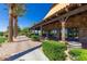 Elegant clubhouse exterior with stone accents, covered patio, manicured landscaping, and picturesque views at 175 E Santa Lucia Ln, Queen Creek, AZ 85140