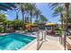 Inviting community pool with lounge chairs, umbrellas, and lush landscaping, creating a perfect relaxation spot at 175 E Santa Lucia Ln, Queen Creek, AZ 85140