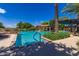 Inviting community pool with lounge chairs, umbrellas, palm trees, and manicured landscaping for relaxation at 175 E Santa Lucia Ln, Queen Creek, AZ 85140