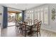 Dining room with seating for eight, slider to outdoor living, chandelier and wood-look tile flooring at 175 E Santa Lucia Ln, Queen Creek, AZ 85140