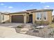 Inviting single-story home showcasing desert landscaping, a stone walkway, and an attached two-car garage at 175 E Santa Lucia Ln, Queen Creek, AZ 85140