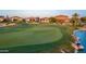 Scenic golf course view featuring a green, sand trap, pond, and houses along the manicured lawn at 175 E Santa Lucia Ln, Queen Creek, AZ 85140