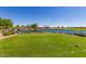 Picturesque view of the golf course features a pond with a waterfall and lush green grass at 175 E Santa Lucia Ln, Queen Creek, AZ 85140