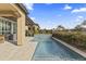 Relaxing swimming pool with decorative tile, a stone waterfall feature, and desert landscaping in the background at 175 E Santa Lucia Ln, Queen Creek, AZ 85140