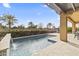 Backyard swimming pool with travertine decking, a stone waterfall feature, and desert landscaping in the background at 175 E Santa Lucia Ln, Queen Creek, AZ 85140