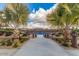 View of the community tennis courts surrounded by palm trees and lush landscaping at 175 E Santa Lucia Ln, Queen Creek, AZ 85140