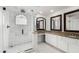 Bathroom featuring double sinks, granite counters, and a glass-enclosed shower at 19333 N 68Th Ave, Glendale, AZ 85308