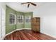 Bedroom with hardwood floors features a unique armoire and several windows at 19333 N 68Th Ave, Glendale, AZ 85308