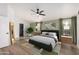 Light-filled bedroom with a ceiling fan, stylish decor, and calming green accents at 19333 N 68Th Ave, Glendale, AZ 85308