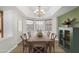 Dining room with a modern light fixture, table with seating, and a cabinet at 19333 N 68Th Ave, Glendale, AZ 85308