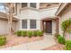 Inviting front entrance with brick archway, decorative wreath, and well-maintained landscaping at 19333 N 68Th Ave, Glendale, AZ 85308