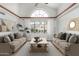 Bright living room with vaulted ceilings, neutral furniture, and large arched window at 19333 N 68Th Ave, Glendale, AZ 85308