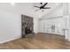 Spacious living room featuring a rock fireplace and a ceiling fan at 19333 N 68Th Ave, Glendale, AZ 85308