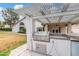 Outdoor kitchen with built-in grill under a covered patio at 19333 N 68Th Ave, Glendale, AZ 85308