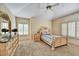 Cozy bedroom featuring a queen-size bed, dresser, and plantation shutters at 19400 N Westbrook Pkwy # 320, Peoria, AZ 85382