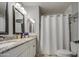 Bathroom featuring double sink vanity with granite countertop and a shower with a white shower curtain at 2006 W Summit Pl, Chandler, AZ 85224