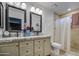 Bathroom with dual sinks, granite counters, and tiled shower at 2006 W Summit Pl, Chandler, AZ 85224