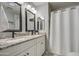 Bathroom featuring double sink vanity with granite countertop and a shower with a white shower curtain at 2006 W Summit Pl, Chandler, AZ 85224