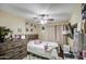 Well-lit bedroom with a wooden dresser, decorative accents, and a cozy bed at 2006 W Summit Pl, Chandler, AZ 85224