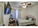 Cozy bedroom with a pink headboard, ceiling fan, and natural light at 2006 W Summit Pl, Chandler, AZ 85224