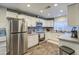 Bright kitchen with stainless steel refrigerator, white cabinets, and granite countertops at 2006 W Summit Pl, Chandler, AZ 85224