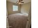 This bedroom offers a neutral color palette, carpet, and a large window providing natural light at 2010 E Indigo Dr, Chandler, AZ 85286