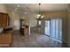 Open-concept dining area with tile floors, a sliding door to the patio, and kitchen access at 2010 E Indigo Dr, Chandler, AZ 85286