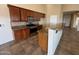 Modern kitchen featuring dark wood cabinets, granite countertops, and stainless steel appliances at 2010 E Indigo Dr, Chandler, AZ 85286