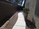 Narrow side yard featuring decorative rock and a concrete walkway that extends to a gate at 2010 E Indigo Dr, Chandler, AZ 85286