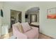 Sitting area with pink chair shows the bedroom beyond with doors to the bathroom beyond at 2011 W Calle De Las Estrella --, Phoenix, AZ 85085