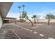 Expansive backyard featuring a covered patio and low-maintenance gravel landscaping at 20210 N 124Th Dr, Sun City West, AZ 85375