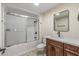 Bathroom featuring a tub shower combo, wood vanity, and light countertops at 20210 N 124Th Dr, Sun City West, AZ 85375