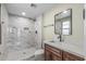 Modern bathroom featuring a walk-in shower with large tiles and a stylish vanity at 20210 N 124Th Dr, Sun City West, AZ 85375