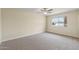 This bedroom features neutral carpet and a ceiling fan, providing a cozy and comfortable space at 20210 N 124Th Dr, Sun City West, AZ 85375